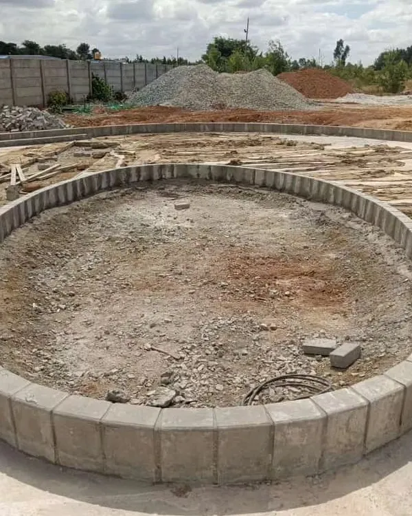 The first step is laying the foundation. Here, you can see the custom circular planter bed, a hardscape feature, built on the prepared site before any soil or plants are added.