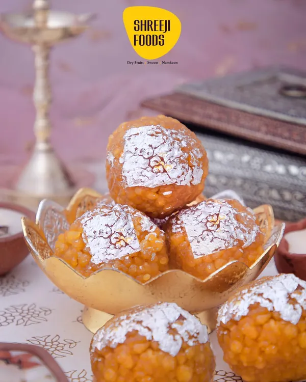 This is my classic Motichoor Laddoo, made the traditional way. Each laddoo is soft, fresh, and has that perfect sweetness, decorated with a bit of silver varq. It's the perfect sweet for any big celebration, from a wedding to Diwali.
