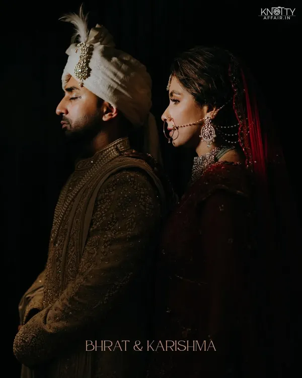 An artistic, moody portrait of the couple back-to-back. This dramatic lighting and composition showcases our creative approach to couple photography.