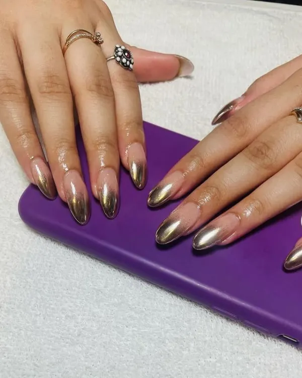 Go for gold with these stunning, full-coverage metallic gold chrome nails, shaped into a sharp almond point for a truly liquid-metal look.