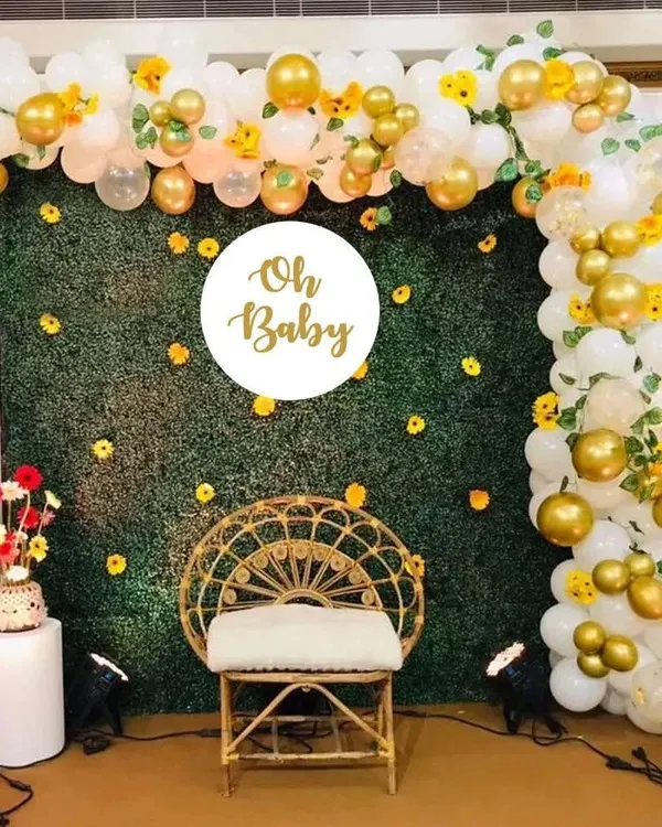 (Hero Item) I love creating these elegant photo backdrops for baby showers. This setup features an artificial green hedge wall, a custom 'Oh Baby' sign, and a beautiful arch of white and gold balloons, perfect for a chic and memorable celebration.