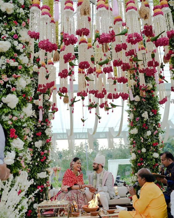 A fairytale moment under a canopy of thousands of flowers. This mandap was designed to feel like a secret garden, creating an intimate and romantic setting for the couple's vows.