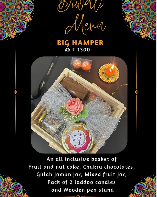 My Big Hamper for Diwali, an all-inclusive basket with a Fruit and Nut Cake, Chakra chocolates, a Gulab Jamun jar, and non-edible gifts like Laddoo candles and a wooden pen stand.