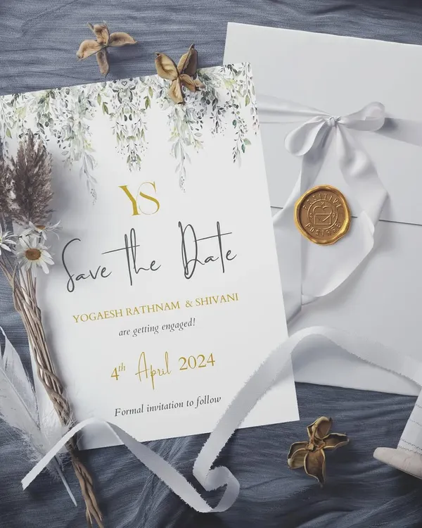 A Save the Date that is pure enchantment. This design for Yogaesh and Shivani blends a golden monogram and text with delicate watercolor leaves, creating a look that is both modern and timelessly romantic.