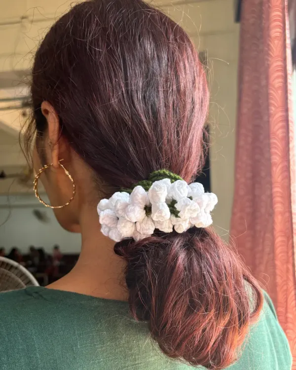 This is my handmade crochet gajra, a modern twist on a classic hair accessory. I love how it looks in a simple ponytail, adding a touch of timeless elegance that, unlike real flowers, will last forever.