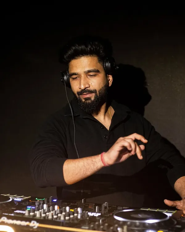 Deep in focus, curating the next track. This is a candid shot of me at the Pioneer DJ console, completely immersed in the music and the moment.