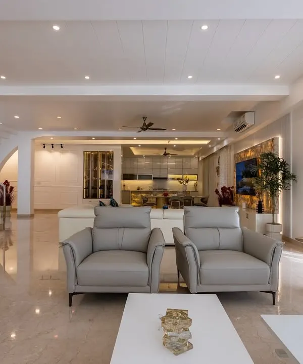This open-plan living area from the Diamond District project showcases a seamless flow between spaces. I used a consistent palette of soft neutrals, polished marble floors, and comfortable, modern furniture to create an atmosphere of understated luxury.