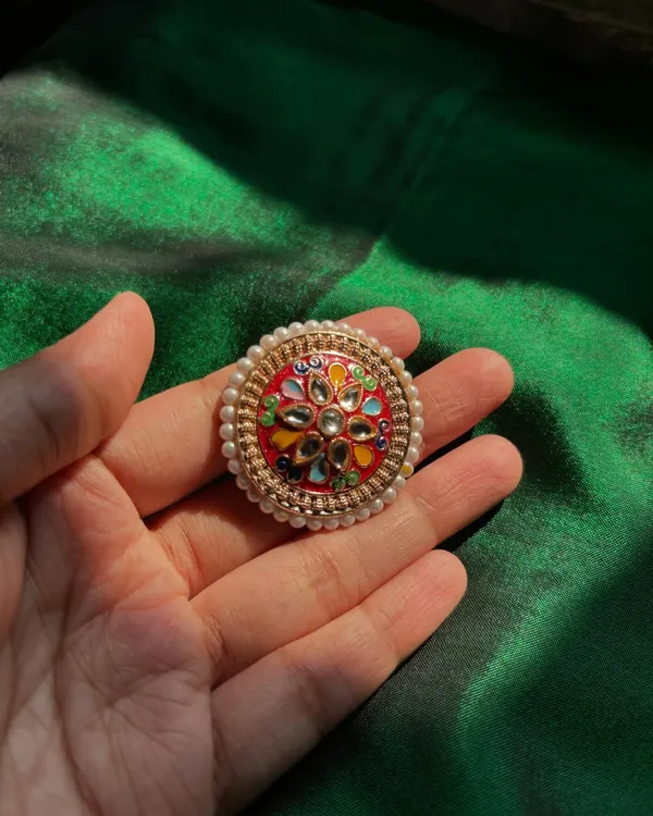 Be precious, be you. This is a beautiful oversized ring from our collection, featuring colourful Meenakari work and a pearl border.