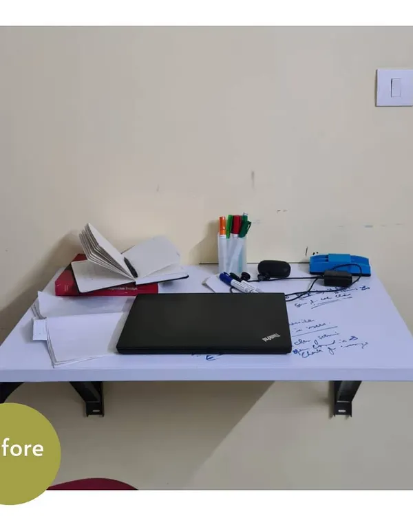 A simple work-from-home desk before organizing. Even a small space can quickly become cluttered with papers, a laptop, and pens.