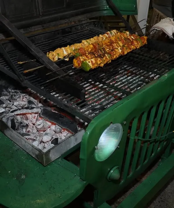 Our custom-built jeep grill is always a conversation starter. Here, we're grilling marinated paneer skewers over hot coals, adding a theatrical and delicious element to the event.