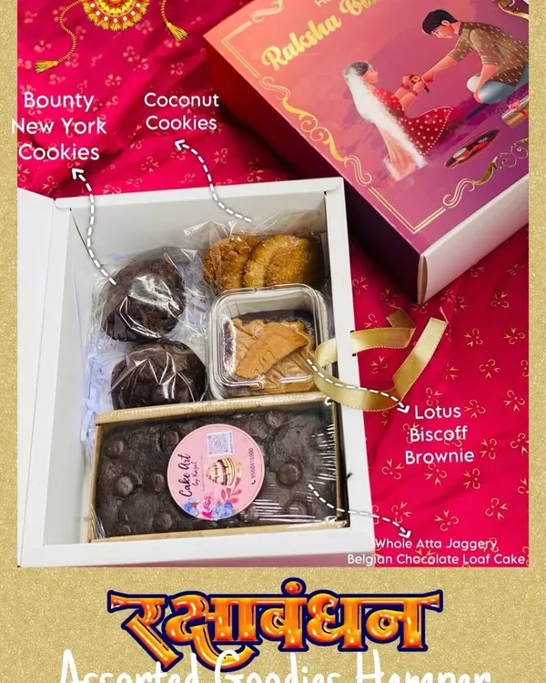 This is my signature Raksha Bandhan Assorted Goodies Hamper. It's a curated box containing a whole atta jaggery loaf, a Lotus Biscoff brownie, and two types of cookies, showcasing the variety you can include in a custom gift.