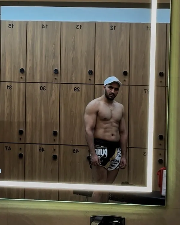 A progress check in the locker room mirror. Staying accountable with visual tracking is a huge part of any fitness journey, showing the real results of your hard work.