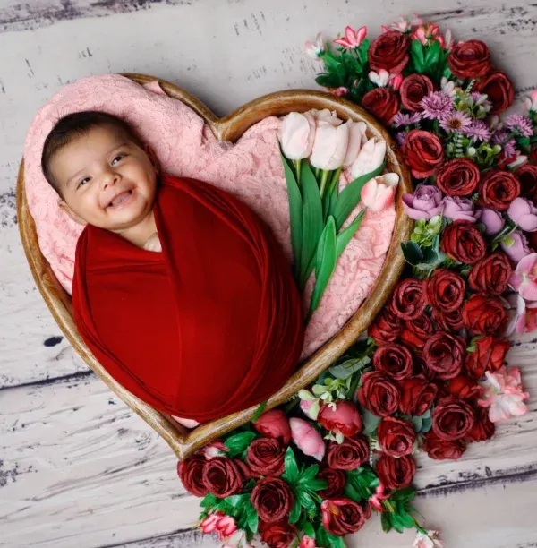 A smile that outshines the brightest flowers. I love creating these heart-shaped floral arrangements to cradle your baby in beauty.