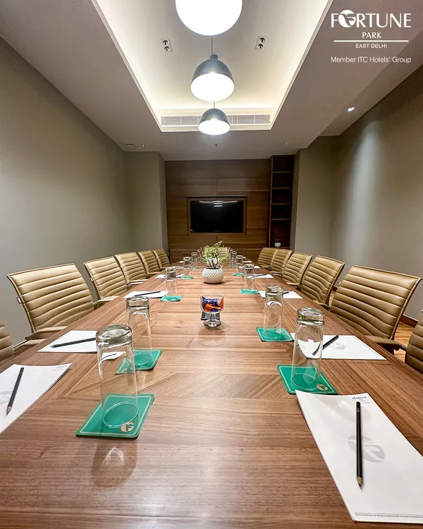 This is my primary boardroom, meticulously prepared for your next strategic session. The expansive table, ergonomic chairs, and integrated audio-visual technology create an environment where focus and decision-making come naturally.
