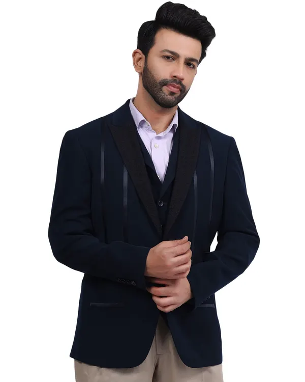 A male model looking sharp in a navy blue three-piece suit. The clean white background and professional lighting make this a perfect shot for a formal wear catalogue or e-commerce store.
