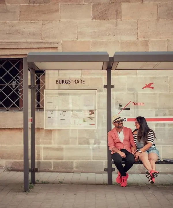 A quiet moment shared by a couple at a bus stop in Germany. This destination shoot shows our ability to tell love stories anywhere in the world, finding romance in ordinary places.