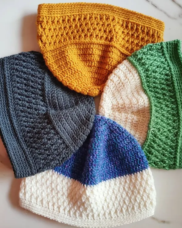 This is a collection of unisex beanies I made, each featuring a textured Alpine stitch panel. It's a versatile pattern that looks great in any color, from mustard yellow to classic grey.