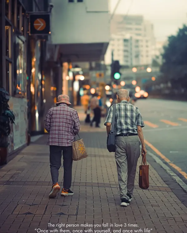 An elderly couple walking together on a sidewalk in Kowloon, Hong Kong. This is the heart of street photography for me, capturing universal stories of love and companionship in the middle of a bustling city.