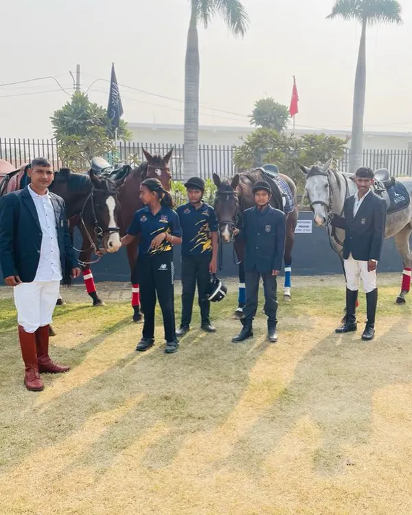 Our instructors and students stand proudly with their horses. We foster a team environment where everyone supports each other's growth.
