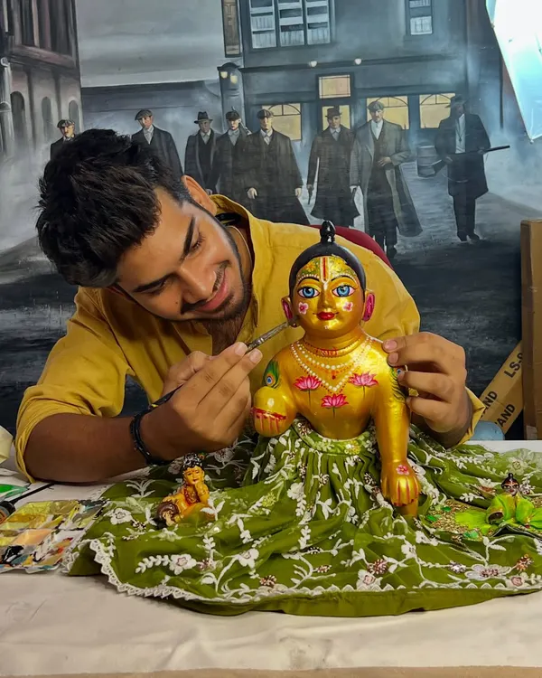 Here I am, adding the final touches to a custom-painted Kanha idol. This work is a form of meditation for me, offering a piece of my soul in every detail.