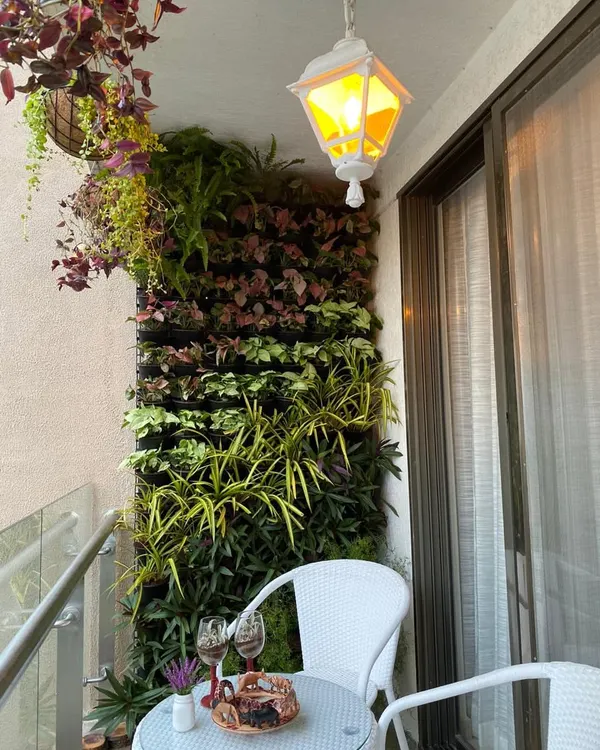 A perfect example of how a vertical garden can maximize greenery in a small space. This living wall on a client's balcony serves as a beautiful, natural backdrop that requires minimal floor space.