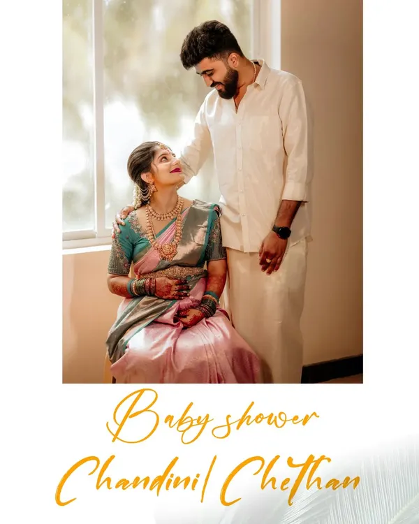 An intimate portrait from a baby shower, where the couple shares a quiet moment of connection. The soft window light and their traditional attire create a timeless and elegant feel, highlighting the love that surrounds them.