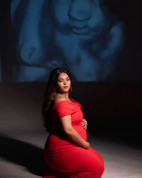 In the quiet of the studio, we projected her baby's sonogram, the very first picture, onto the wall. It’s a powerful and deeply personal way I help mothers connect with the little life they are nurturing. This is more than a portrait; it's a conversation before the first hello.