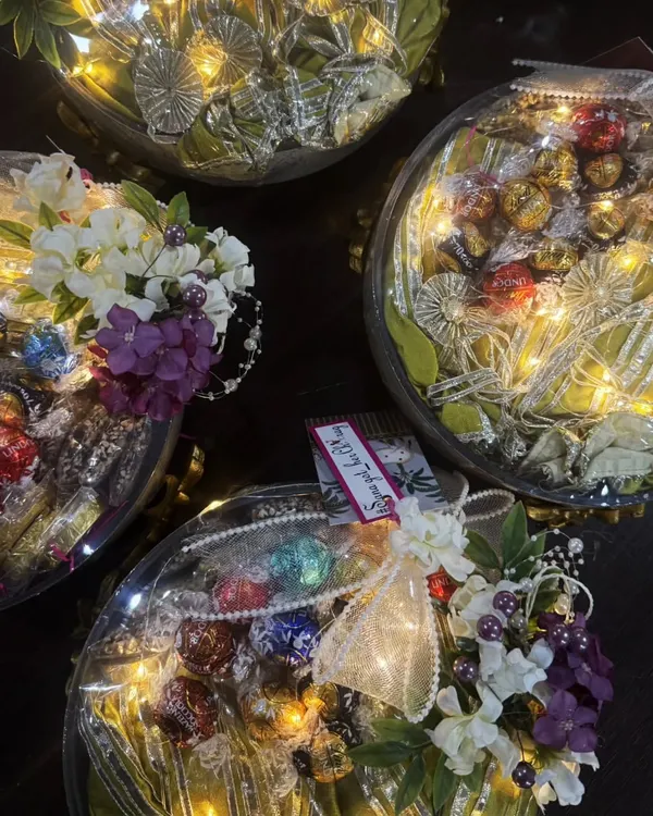 An overhead view of a bulk order of my premium hampers. Each one is thoughtfully curated and beautifully packed with fairy lights, ribbons, and flowers. I ensure every gift, no matter the quantity, feels personal and special.