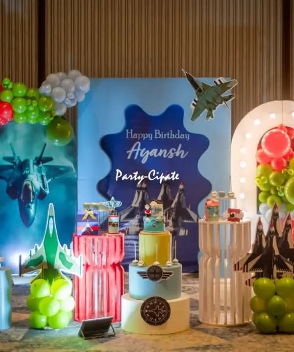 Ayansh's fighter jet party was a blast to design. The main stage featured a custom backdrop with jets, balloon clouds, and a light-up number '8' for his eighth birthday.