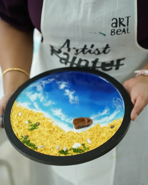 A close-up view of a stunning resin beach art piece, showcasing the glossy finish and intricate details of the waves and sand. This is one of our most popular workshops, and you can create a masterpiece just like this.