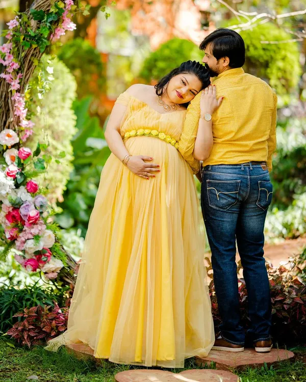 A truly tender moment, with the mother-to-be resting her head on her partner's shoulder. This candid style of couple photography captures genuine emotion and connection.
