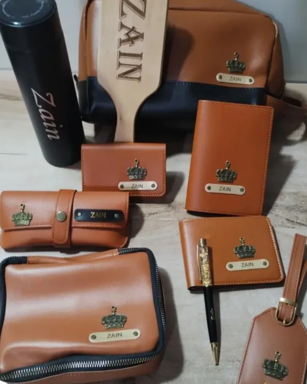 A complete personalized leatherette set in tan and black. This combo includes a travel pouch, wallet, passport cover, sunglass case, card holder, luggage tag, and a custom wooden comb.