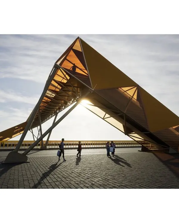 This render captures the sculptural quality of our pedestrian footbridge design. The structure is conceived as a gentle deformation of a simple rectangular tube, creating a dynamic form against the sky.