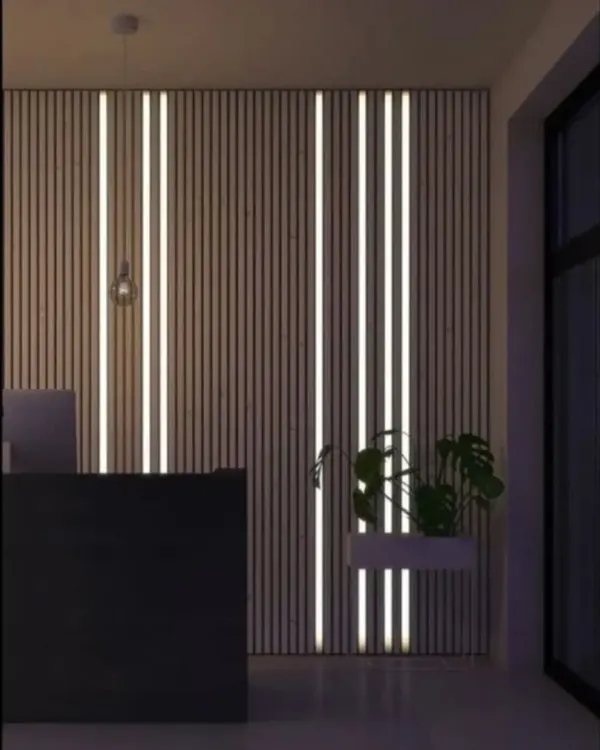 This is a custom-designed feature wall with vertical wood slats and integrated LED strip lighting. This design not only acts as a stunning visual element but also provides ambient light, perfect for a modern reception or lounge area.