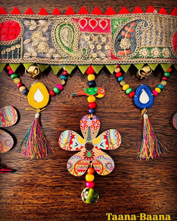This is a close-up of my 'Taana Baana' toran, where every detail is pure handmade joy. I love combining traditional paisley lace with my own art on wood, colorful beads, and little tassels that dance in the breeze.