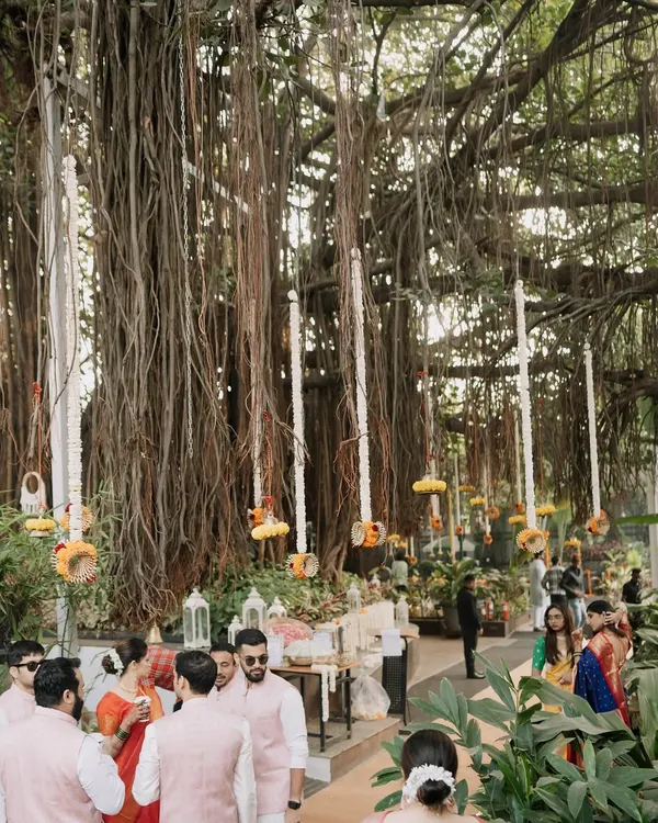 A breathtaking view of an event set under a massive banyan tree. I used the hanging aerial roots as a natural part of the decor, adorning them with long strings of white flowers for a magical effect.