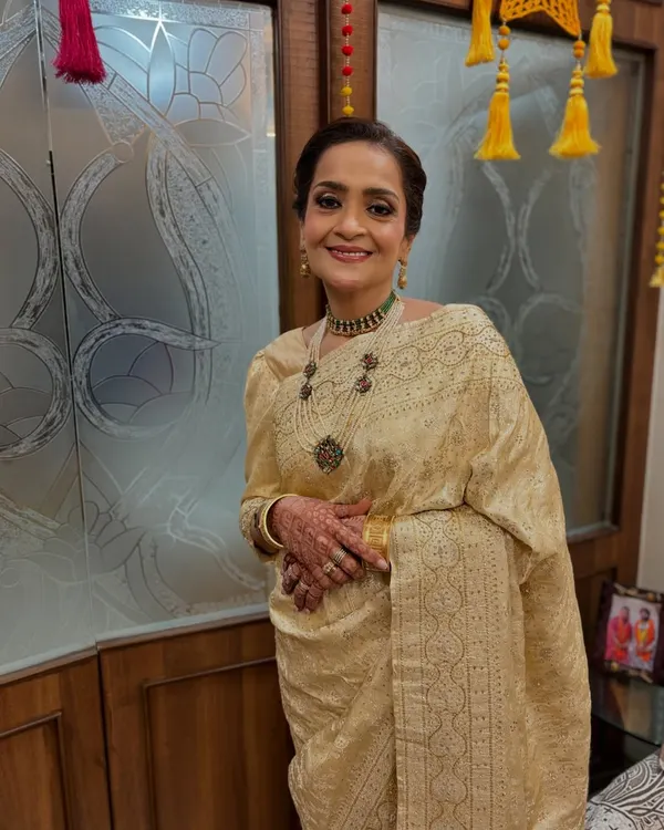 An elegant and regal look for the mother of the bride. I created a sophisticated twisted bun that is both classic and stylish, perfectly complementing her beautiful saree and jewelry.