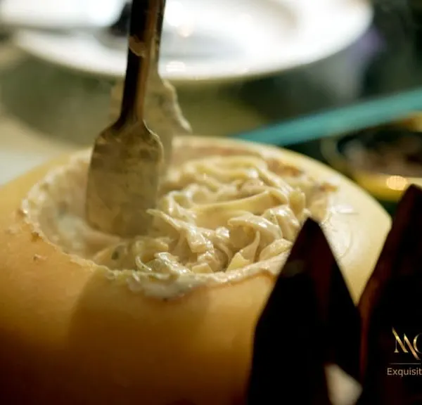 The centerpiece of our Italian Pasta Studio, where fresh fettuccine is tossed in a wheel of Parmigiana Reggiano. This live station offers an interactive and theatrical culinary experience for your guests, finished with luxurious French black truffles for an unforgettable taste.