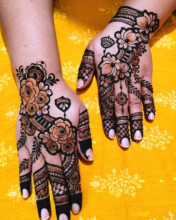 This is a bold floral design with shaded roses and solid-filled fingertips. The contrast between the delicate flowers and the dark tips creates a very modern and eye-catching look.
