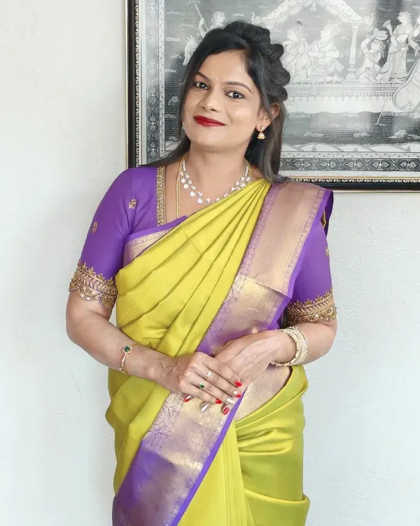 Kalyani looking elegant for a family function in a beautiful lime green and purple silk saree. The look features a classic red lip and a simple, graceful hairstyle.