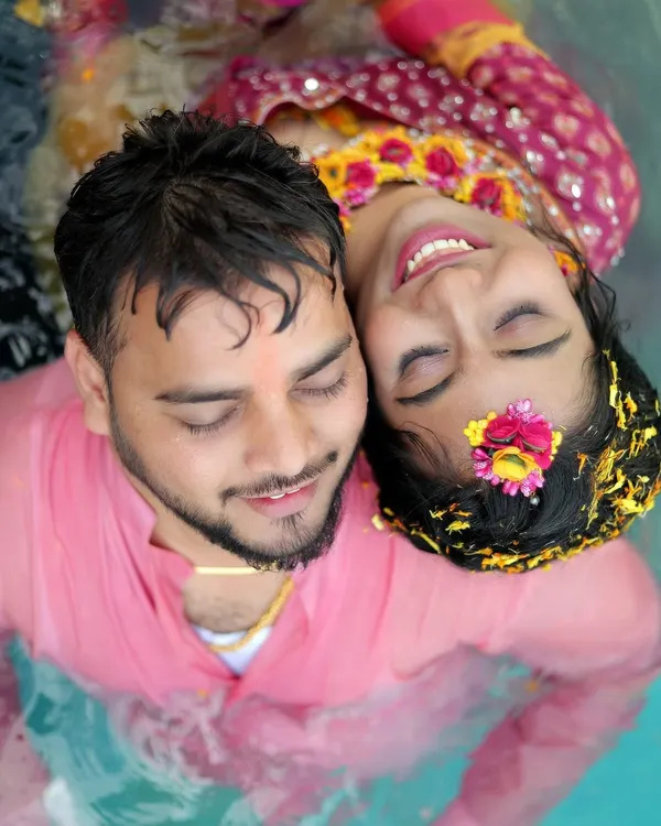 A beautiful aerial shot of the couple relaxing in a pool during their Haldi ceremony, a perfect blend of tradition and fun.
