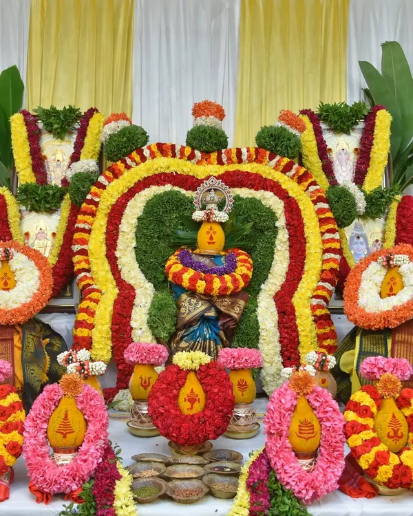 The beautifully decorated kalash and deities, central to any pooja ceremony. I capture the vibrant colors of the flower arrangements and the sacred setup in sharp detail.