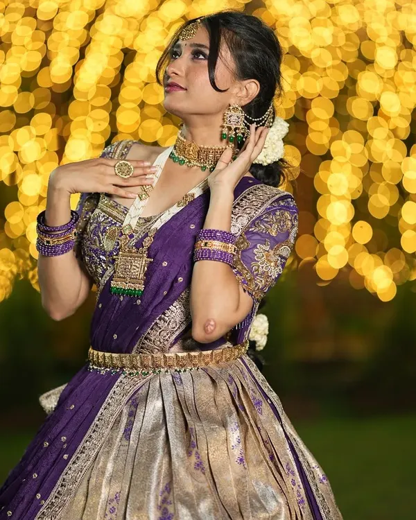 This is what I love to create: a complete bridal look that feels like a dream. This purple and silver half saree is a perfect example of semi-bridal magic, with detailed zardosi embroidery on the blouse and a flowing lehenga that makes you feel like royalty.