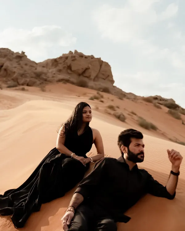 A majestic portrait in the Dubai desert. We posed the couple on the dunes to create a powerful image that feels both editorial and romantic, with the vast landscape stretching out behind them.