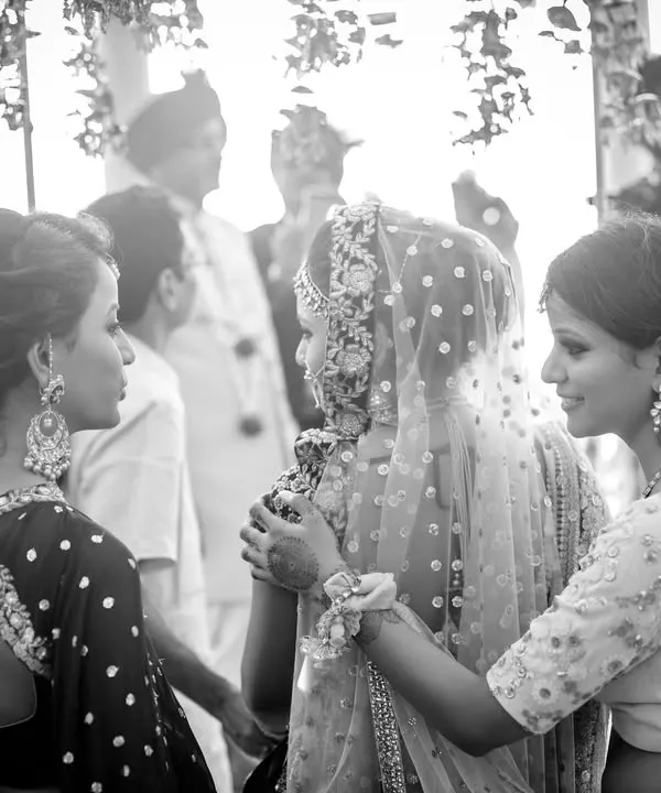 A bride being comforted by her sisters just before the ceremony. This black and white photo captures the mix of happiness and sadness, the letting go and the new beginnings that define a wedding day.