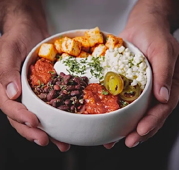 A bowl full of happiness, held in our hands. This is our promise of a fresh, flavorful, and satisfying meal, delivered right to you.