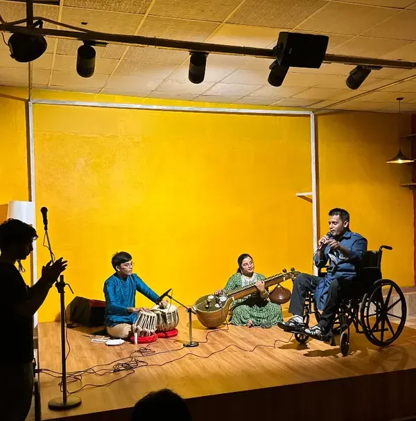 A wide shot of our stage during an inclusive classical music night. The warm lighting, professional sound setup, and engaged audience show how our space transforms into an intimate performance venue.