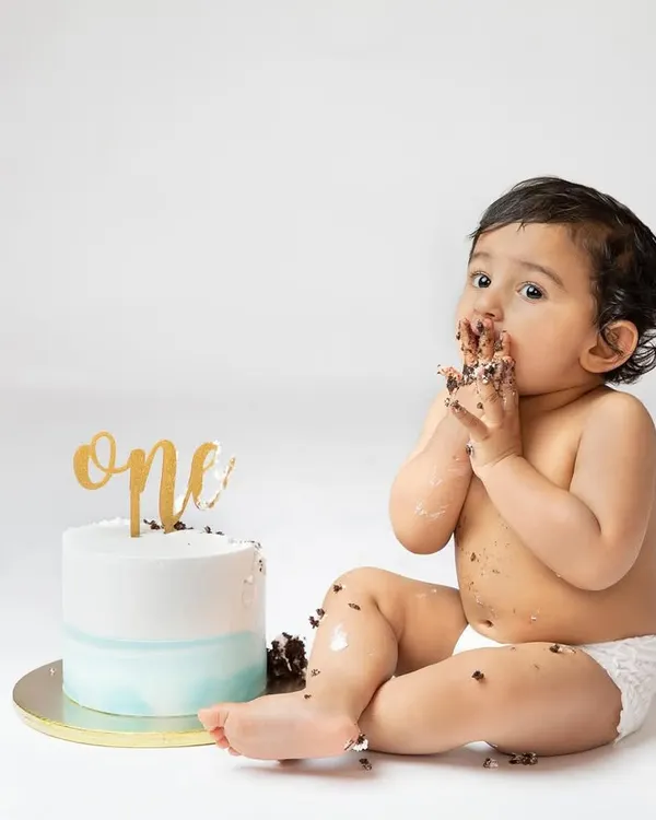 Getting right into the cake. A first birthday cake smash is all about letting them have fun and get messy, and I'm there to capture every sweet moment.