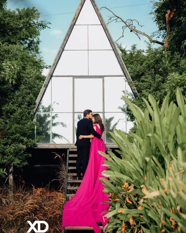 (Hero Item) This is the kind of grand, romantic shot we can create. I captured this moment at a popular Bangalore studio, using the unique A-frame architecture to create a stunning backdrop. The flowing gown, included in my rental outfit collection, adds a perfect touch of drama for a memorable pre-wedding photo.