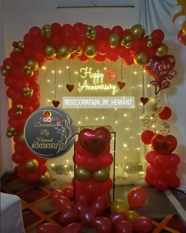 This classic red and gold anniversary setup is one of my most requested styles. It features a full balloon arch, warm fairy lights for ambiance, and a custom neon sign to create a perfect photo backdrop for your celebration at home.